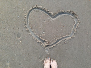 drawing hearts in the sand