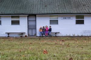 4 kids sitting on bench