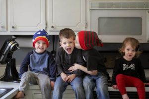 four kids sitting funny