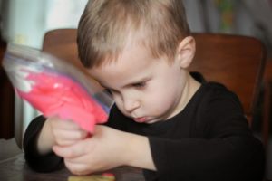 boy decorating christmas cookies