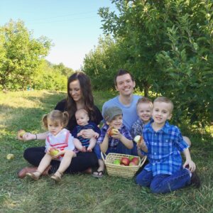 large family with basket of apples