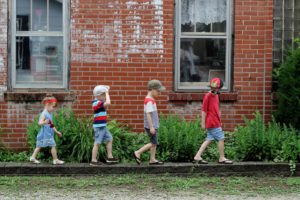 4 kids walking in a line