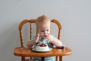 birthday boy with messy cake hands