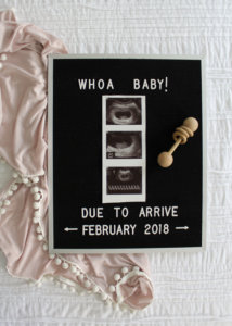 birth announcement wording on black letter board with ultrasound picture